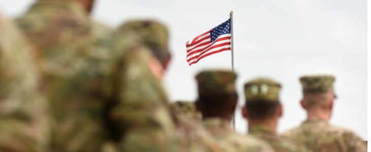 military troops lined up in front of an american flag